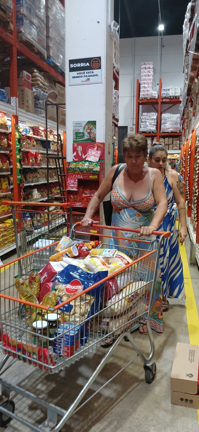 Old woman wearing a dress without a bra and with a very low neckline. #90RTSvuX