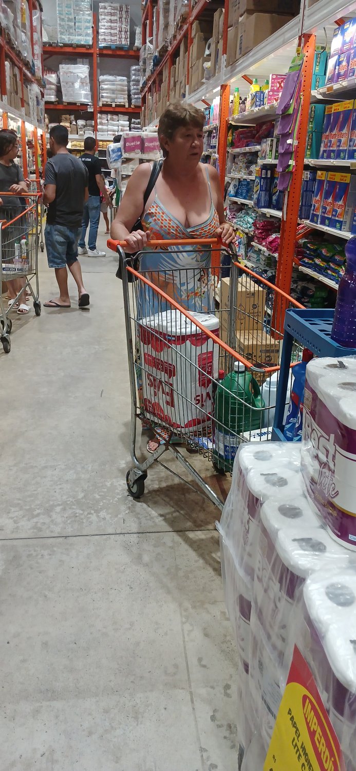 Old woman wearing a dress without a bra and with a very low neckline. #C6vPo5f9