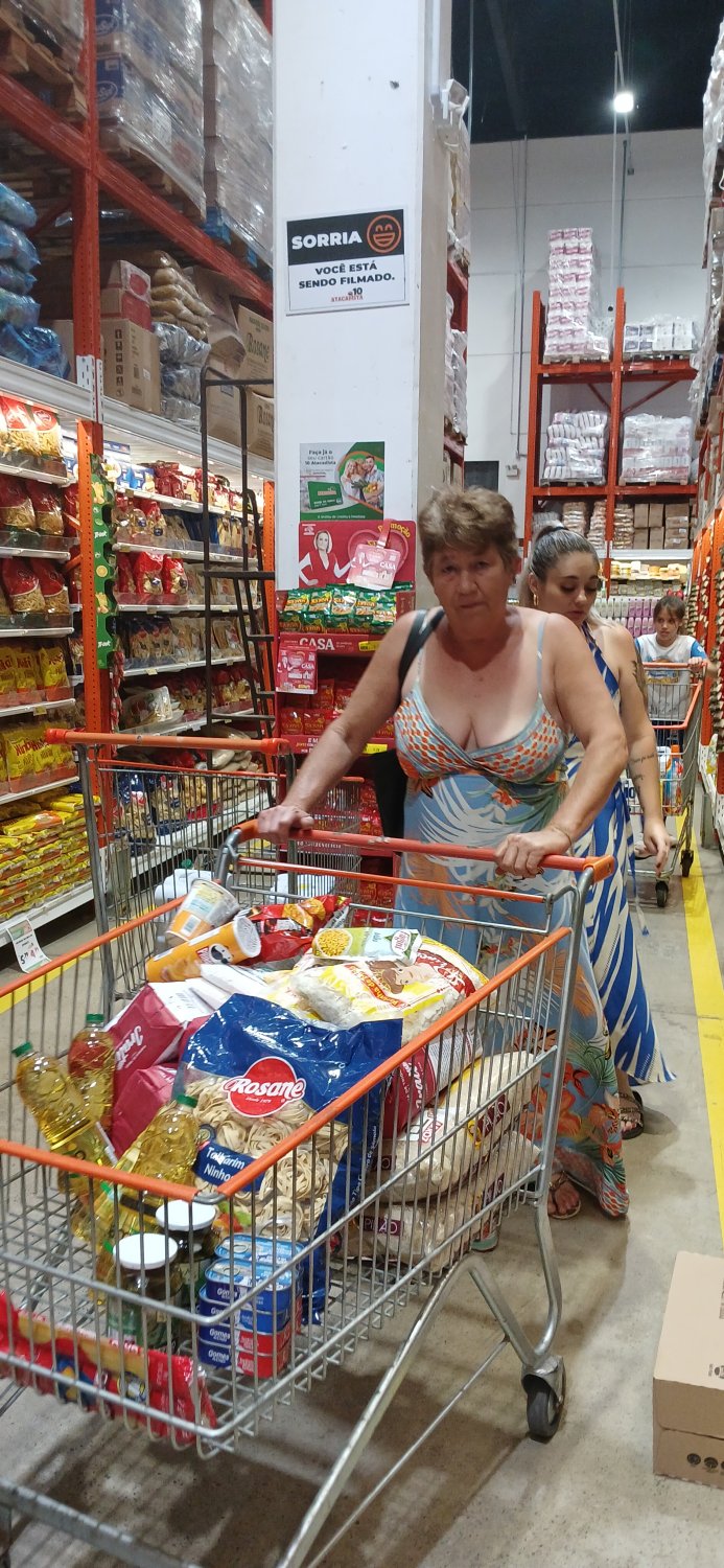 Old woman wearing a dress without a bra and with a very low neckline. #qvAlan5z